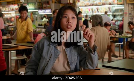 Young Chinese College Girl Ordering Food At A Busy Crowded Singapore Hawker Center With A Bunch Of Elderly People Aro Stock Photo