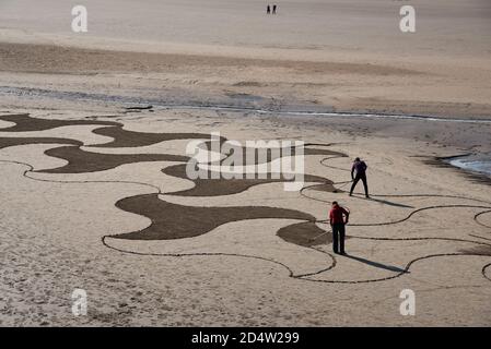 Arnside, Cumbria, UK. 11th Oct, 2020. Lancaster artist Paul Speight's latest creation of sand art at White Creek, Arnside, Cumbria where the unique silt sand enables him to work with three different tones. Tide conditions need to leave the sand dry enough to achieve the contrasting textures but not too dry which makes it too hard to rake. Credit: John Eveson/Alamy Live News Stock Photo