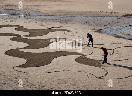 Arnside, Cumbria, UK. 11th Oct, 2020. Lancaster artist Paul Speight's latest creation of sand art at White Creek, Arnside, Cumbria where the unique silt sand enables him to work with three different tones. Tide conditions need to leave the sand dry enough to achieve the contrasting textures but not too dry which makes it too hard to rake. Credit: John Eveson/Alamy Live News Stock Photo