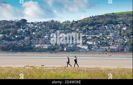 Arnside, Cumbria, UK. 11th Oct, 2020. A beautiful afternoon at Arnside, Cumbria as dog walkers enjoy the sand of Morecambe Bay with Grange-over-Sands as a backdrop. Credit: John Eveson/Alamy Live News Stock Photo