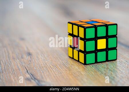 Rubik's cube on the white or wooden background. Rubik's Cube inv Stock Photo
