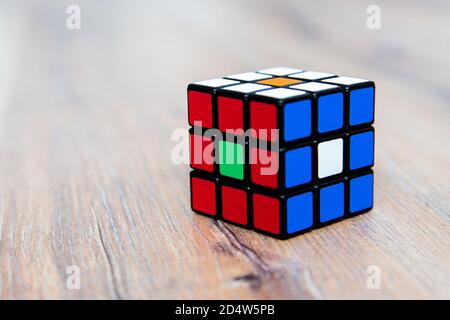 Rubik's cube on the white or wooden background. Rubik's Cube inv Stock Photo