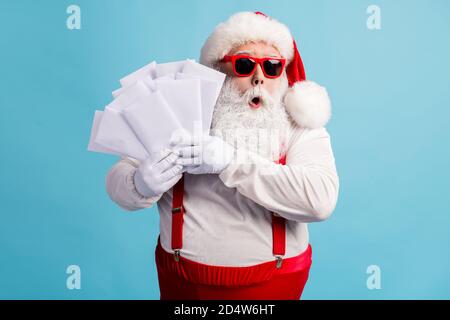 Portrait of his he nice attractive amazed wondered overwhelmed thick white-haired Santa holding in hand many mail gift wish list lottery isolated Stock Photo