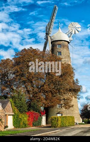 Moulton Tower Mill dominates the sky line in the picturesque village of Moulton Stock Photo