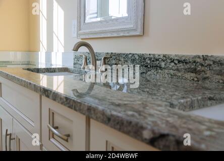 Modern grey marble countertop designer bathroom with sinks bathtub on vanity cabinet Stock Photo
