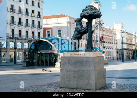 Madrid, Spain - 3rd October, 2020: Sculpture of the Bear and the Strawberry Tree and Metro station in Puerta del Sol square. View of the empty square Stock Photo