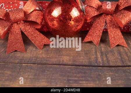 christmas ball and red ribbons on a wooden background. christmas decorations Stock Photo
