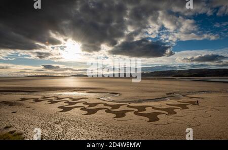 Arnside, Cumbria, UK. 11th Oct, 2020. Lancaster artist Paul Speight's latest creation of sand art at White Creek, Arnside, Cumbria where the unique silt sand enables him to work with three different tones. Tide conditions need to leave the sand dry enough to achieve the contrasting textures but not too dry which makes it too hard to rake. Credit: John Eveson/Alamy Live News Stock Photo