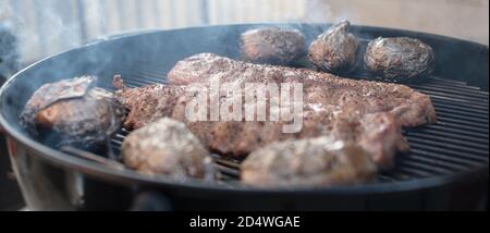 Pork ribs baked to a crisp on a smoky gril Stock Photo