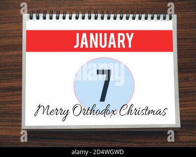 Calendar, January 7th, Merry Orthodox Christmas, on wooden background, illustration Stock Photo