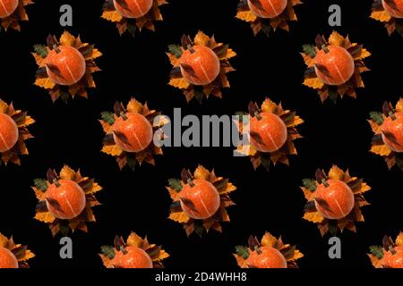Seamless pattern on a black background. Autumn theme. Orange pumpkin fruits lie on autumn leaves. Use for packaging, background, wallpaper. A high res Stock Photo