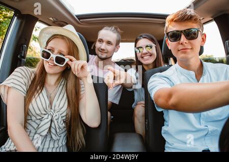 group of friends in car. road trip concept. summer vacation Stock Photo