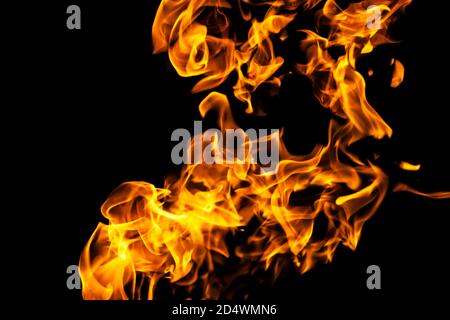 Fire flames on black background isolated. Burning gas or gasoline burns with fire and flames. Flaming burning sparks close-up, fire patterns. Infernal Stock Photo