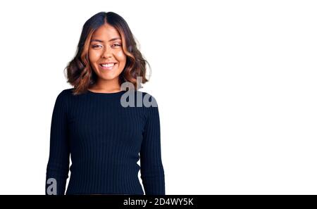 Young beautiful mixed race woman wearing casual clothes with a happy and cool smile on face. lucky person. Stock Photo