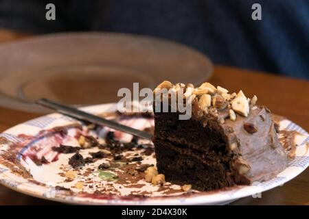 Elderly woman preparing and enjoying baked goods in a kitchen Stock Photo