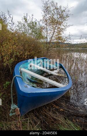 Kinlochard, Scotland, UK. 11th October, 2020. UK Weather: Flooded rowing boat on the shore of Loch Ard which is in Loch Lomond and The Trossachs National Park. Credit: Skully/Alamy Live News Stock Photo