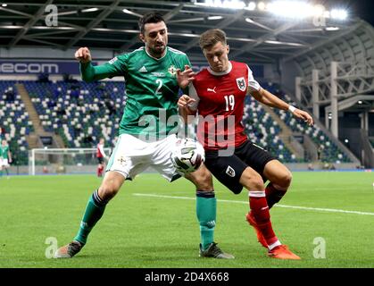 Northern Ireland's Conor McLaughlin (left) and Austria's Christoph Baumgartner battle for the ball during the UEFA Nations League Group 1, League B match at Windsor Park, Belfast. Stock Photo