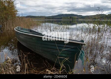 Kinlochard, Scotland, UK. 11th October, 2020. UK Weather: Flooded rowing boat on the shore of Loch Ard which is in Loch Lomond and The Trossachs National Park. Credit: Skully/Alamy Live News Stock Photo