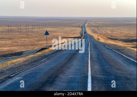 Straight long steppe road in Zag, Kalmykia Stock Photo