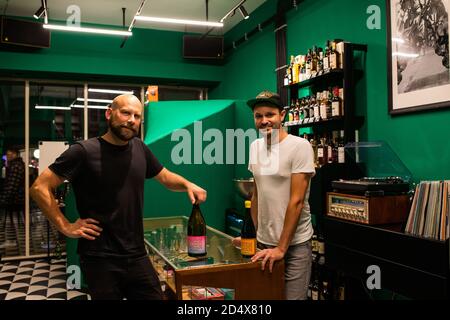 Freiburg, Germany. 09th Oct, 2020. Boris Gröner (l) and Andreas Schöler, the managing directors of the One Trick Pony Bar, are standing above their bar at a sales counter in the shop. The Freiburg bar operators won one of the coveted prizes in the category 'Strategy & Future' at the online Mixology Bar Awards. Credit: Philipp von Ditfurth/dpa/Alamy Live News Stock Photo