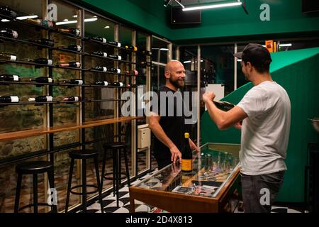 Freiburg, Germany. 09th Oct, 2020. Boris Gröner (l) and Andreas Schöler, the managing directors of the One Trick Pony Bar, are standing above their bar at a sales counter in the shop. The Freiburg bar operators won one of the coveted prizes in the category 'Strategy & Future' at the online Mixology Bar Awards. Credit: Philipp von Ditfurth/dpa/Alamy Live News Stock Photo