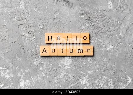 hello autumn word written on wood block. hello autumn text on cement table for your desing, concept. Stock Photo