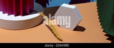 Composition of geometric shapes and colored fans made of cardboard. Concept. Stock Photo