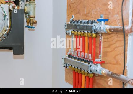 Pipes on central heating distributor of central heating with red valves Stock Photo