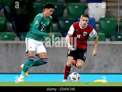 Northern Ireland's Jamal Lewis (left) and Austria's Reinhold Ranftl battle for the ball during the UEFA Nations League Group 1, League B match at Windsor Park, Belfast. Stock Photo