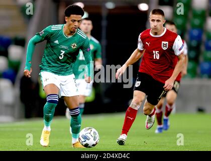 Northern Ireland's Jamal Lewis (left) and Austria's Reinhold Ranftl battle for the ball during the UEFA Nations League Group 1, League B match at Windsor Park, Belfast. Stock Photo