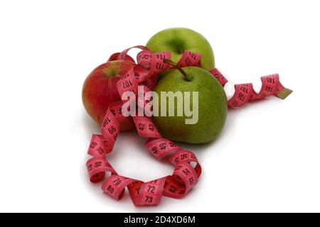 Two fresh green and red apples and green pearlie with pink measuring ribbon isolated on white background Stock Photo