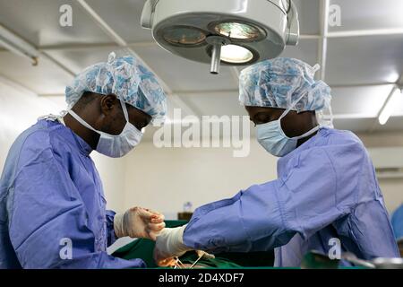 Makeni, Sierra Leone - June 22, 2019: African doctors surgeons operating on a patient in hospital Stock Photo