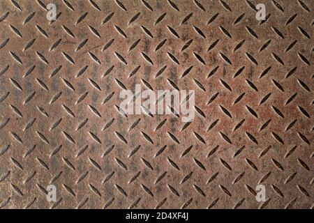Abstract background of old rusty diamondplate rusty metal panel. Grunge brown rough grip industrial steel texture pattern Stock Photo