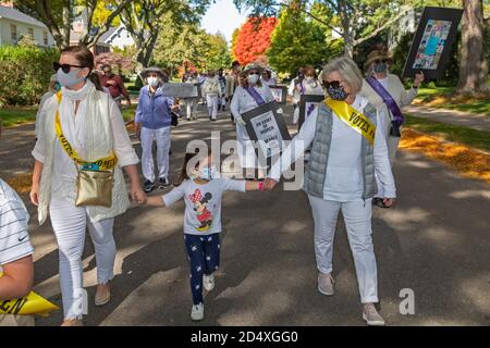 Grosse Pointe, Michigan, USA. 11th Oct, 2020. A parade marks the 100th anniversary of women winning the right to vote. The parade was organized by the American Association of University Women. Credit: Jim West/Alamy Live News Stock Photo