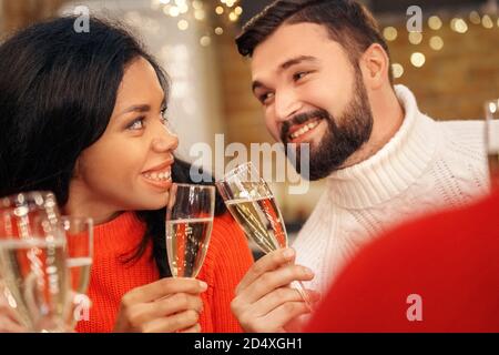 Interracial couple holding glass of champagne in hands Stock Photo