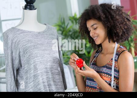 woman working on tailors dummy Stock Photo