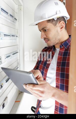 electrician installing energy saving meter Stock Photo