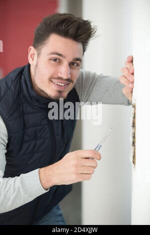 man is working on a wall Stock Photo