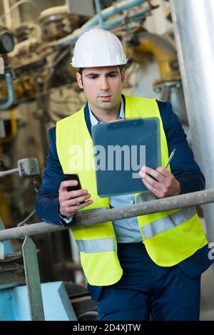 portrait of engineer taking notes at control room Stock Photo