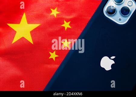 Calgary, Alberta, Canada. Oct 11, 2020. A China flag with an Apple iPhone Max Pro 11. Concept: Apple business relationship with China. Stock Photo