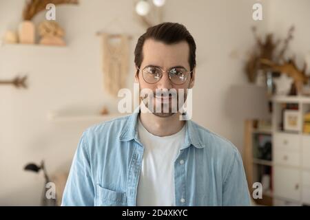 Head shot portrait of young pleasant handsome man in eyeglasses. Stock Photo
