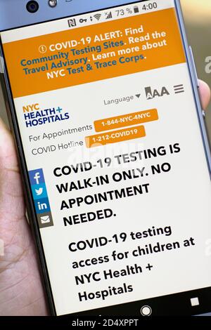 NYC Health + Hospitals Coronavirus COVID-19 Testing, COVID Hotline, Access for Children in New York City, USA displayed on Mobile Phone Screen Stock Photo