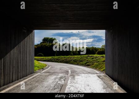 Light and landscape at the end of a dark square tunnel Stock Photo