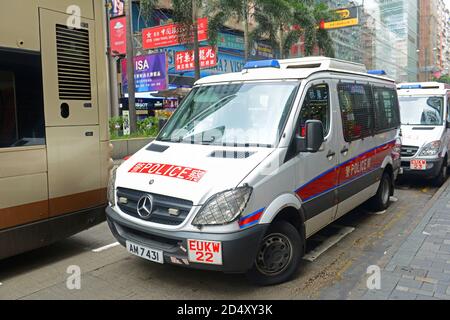 Hong Kong police vehicle on duty on Nathan Road in Kowloon, Hong Kong, China. The Mercedes-Benz Sprinter van is the most commonly seen police vehicles Stock Photo