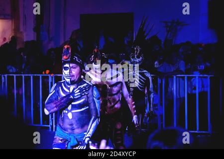 Merida, Mexico - 31 October 2018: Costumed Mayan men with skeleton make up at a 'pok ta pok' ball game performance during day of the dead Stock Photo