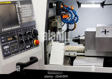 CNC metal lathe machine working with brass bar. Selective focus. Stock Photo