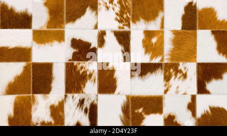Brown and white cow hide patches sewn together Stock Photo