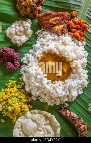 Homemade fish thali meal served at bannana leaf in Kerala state, India.