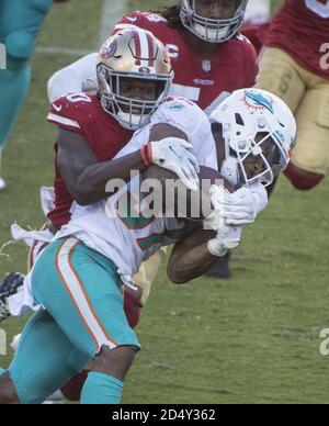 Santa Clara, United States. 11th Oct, 2020. Miami Dolphins running back Myles Gaskin (37) is tackled by San Francisco 49ers free safety Jimmie Ward (20) in the fourth quarter at Levi's Stadium in Santa Clara, California on Sunday, October 11, 2020. The Dolphins beat the 49ers 43-17. Photo by Terry Schmitt/UPI Credit: UPI/Alamy Live News Stock Photo