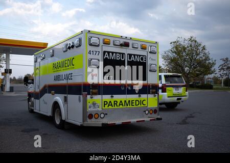 Ottawa, Ontario, Canada - October 10, 2020: An ambulance and utility vehicle operated by the Ottawa Paramedic Service are parked at a gas station. Stock Photo